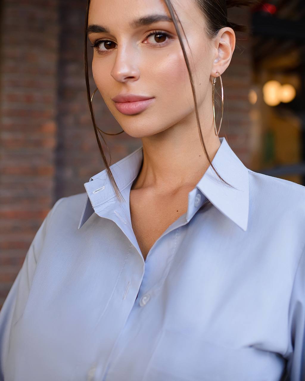Woman wearing a light blue shirt with a blurred background