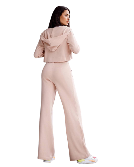 Woman wearing a pink tracksuit on a white background