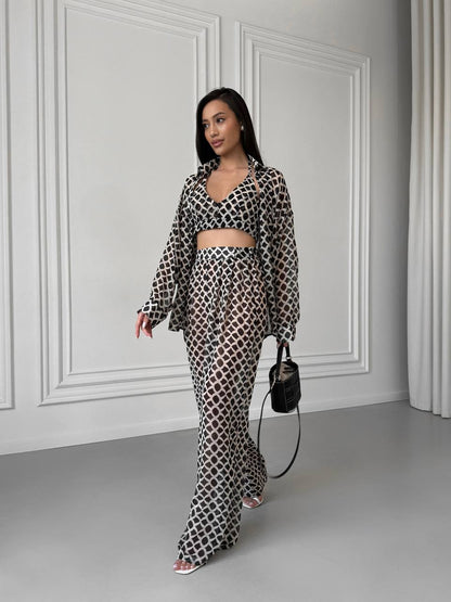 Woman wearing a patterned outfit in a minimalistic room