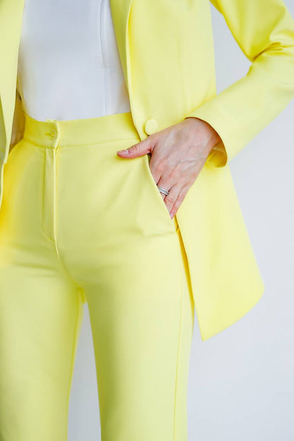 Person wearing a bright yellow suit with a white background