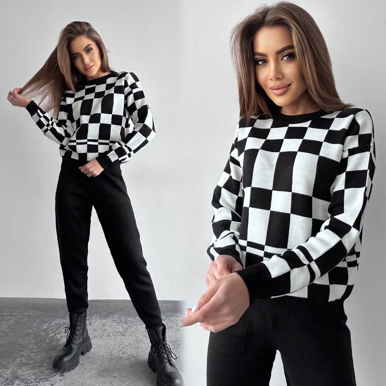 Woman wearing a black and white checkered sweater with a plain background