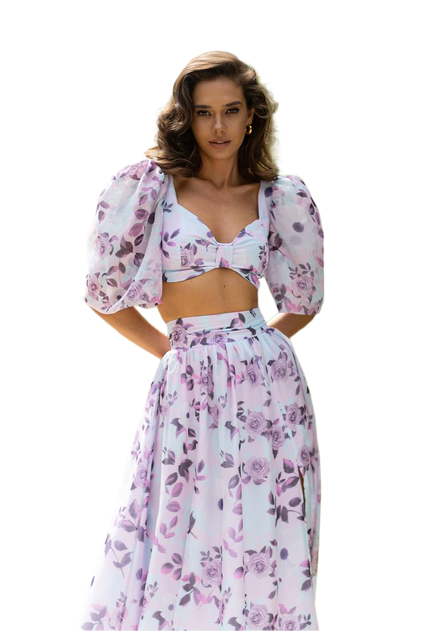 Woman wearing a floral two-piece outfit on a white background