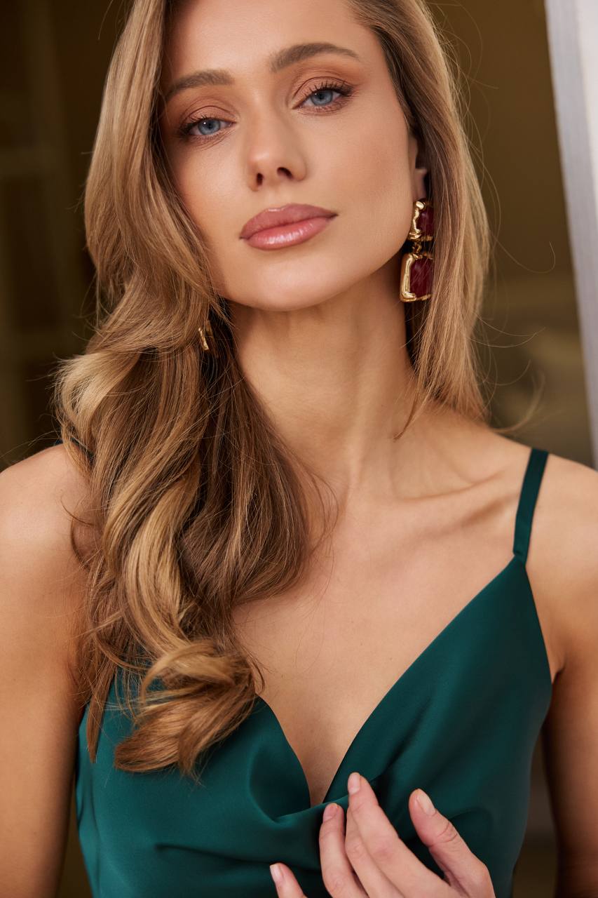 Woman wearing a green dress with a blurred background