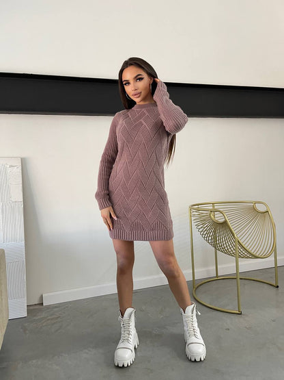 Woman wearing a pink knitted dress with white high-top sneakers in a minimalistic room.