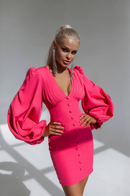 Woman wearing a bright pink dress with puffed sleeves against a gray background