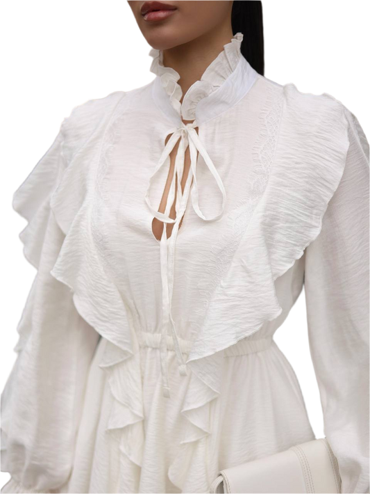 White blouse with ruffled details on a white background