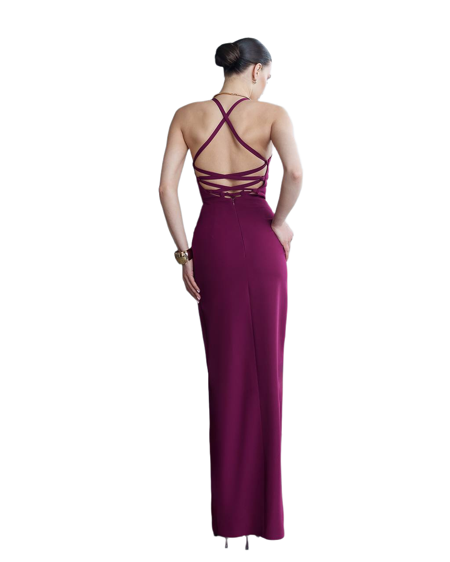 Woman wearing a burgundy evening gown with a backless design on a white background