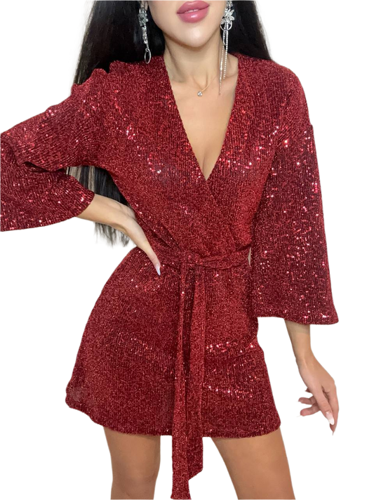 Red sequin dress worn by a model on a white background