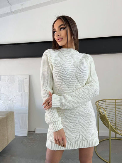 Woman wearing a white knit dress in a modern room.