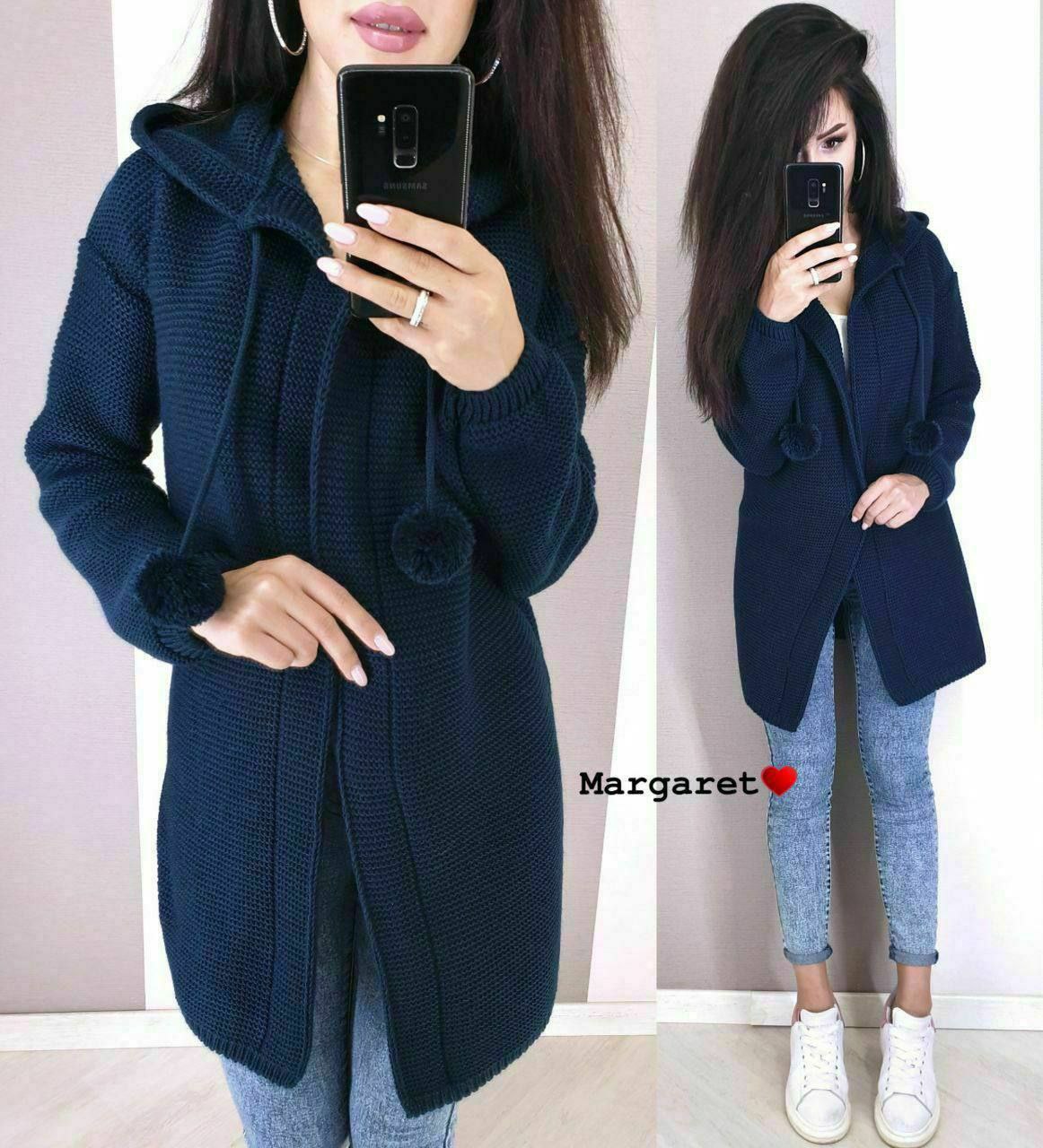 Woman wearing a navy blue coat with a white background