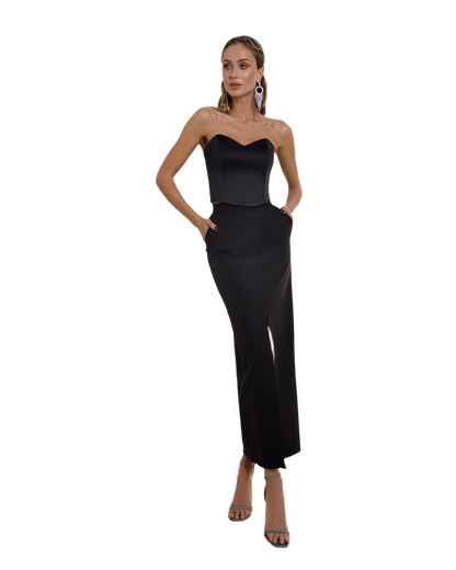 Woman wearing a black strapless gown on a white background