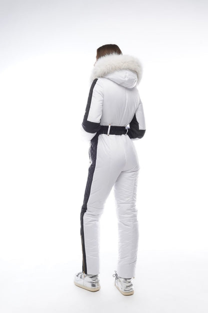 Person wearing a white and black outfit with fur-lined hood on a white background