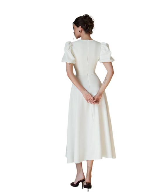 Woman wearing a white dress with short sleeves on a white background