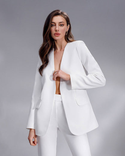 Woman wearing a white suit against a gray background