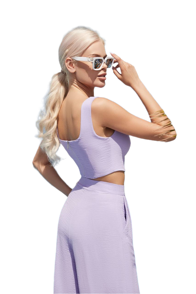 Woman wearing a lavender outfit with cut-out design on a white background