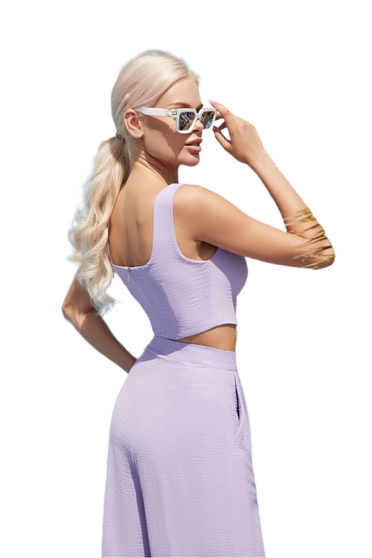 Woman wearing a lavender outfit with cut-out design on a white background