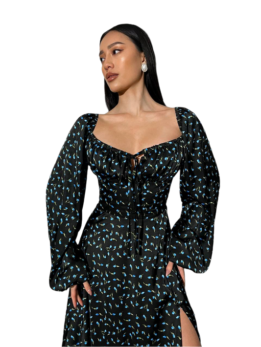 Woman wearing a black floral dress on a white background