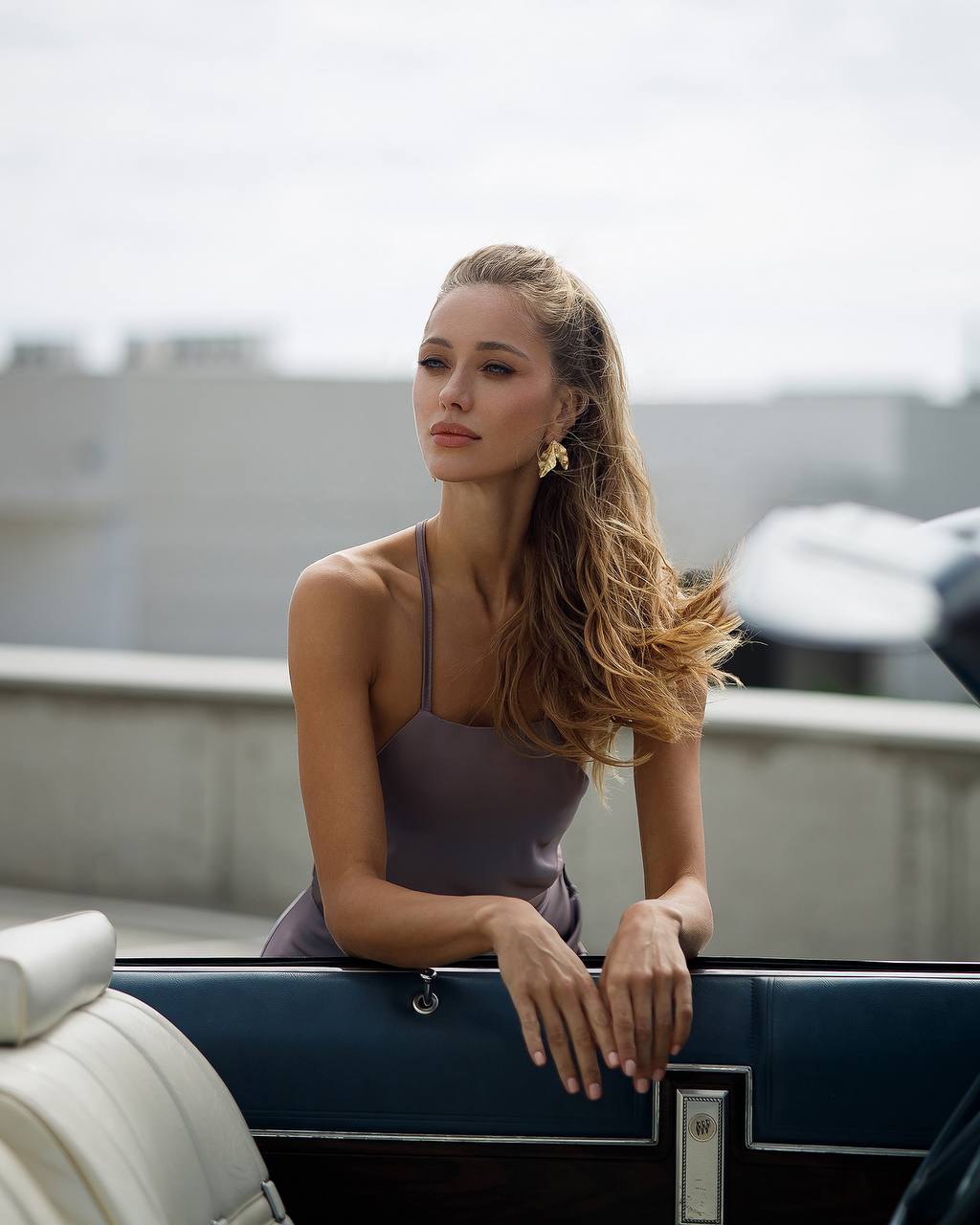Woman in a purple dress sitting on a boat with a blurred background