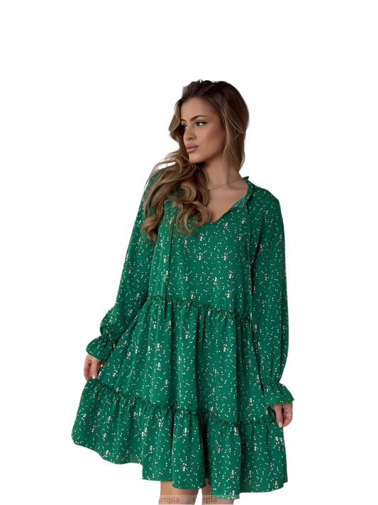 Woman wearing a green floral dress on a white background