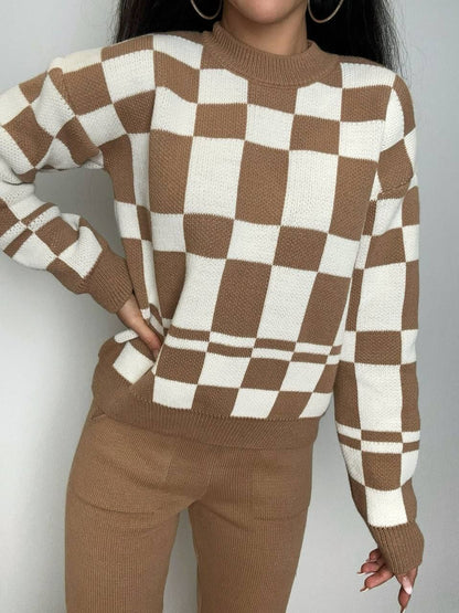 Person wearing a brown and white checkered sweater against a gray background