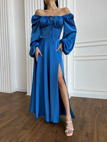 Blue off-shoulder dress with a high slit on a wooden floor.