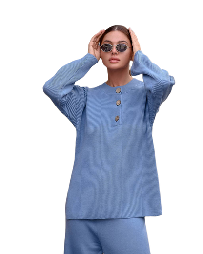 Woman wearing a blue outfit with sunglasses on a white background