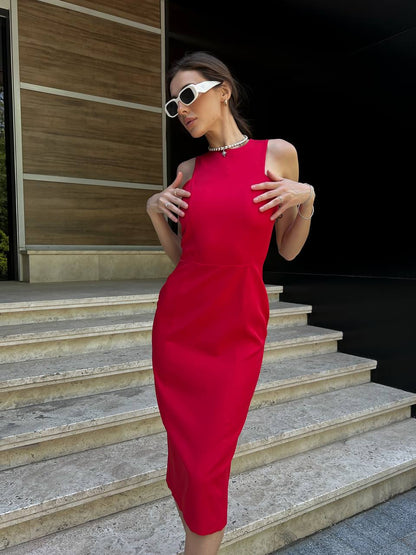 Woman in a red dress standing on steps outdoors