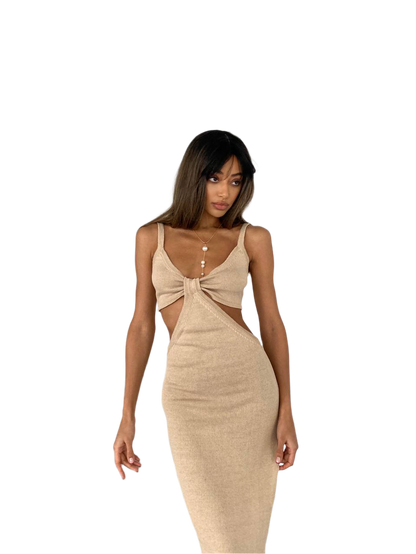 Woman wearing a beige dress with cut-out design on a white background