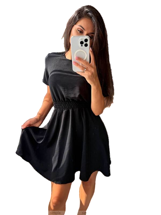 Woman wearing a black dress holding a phone with a white background