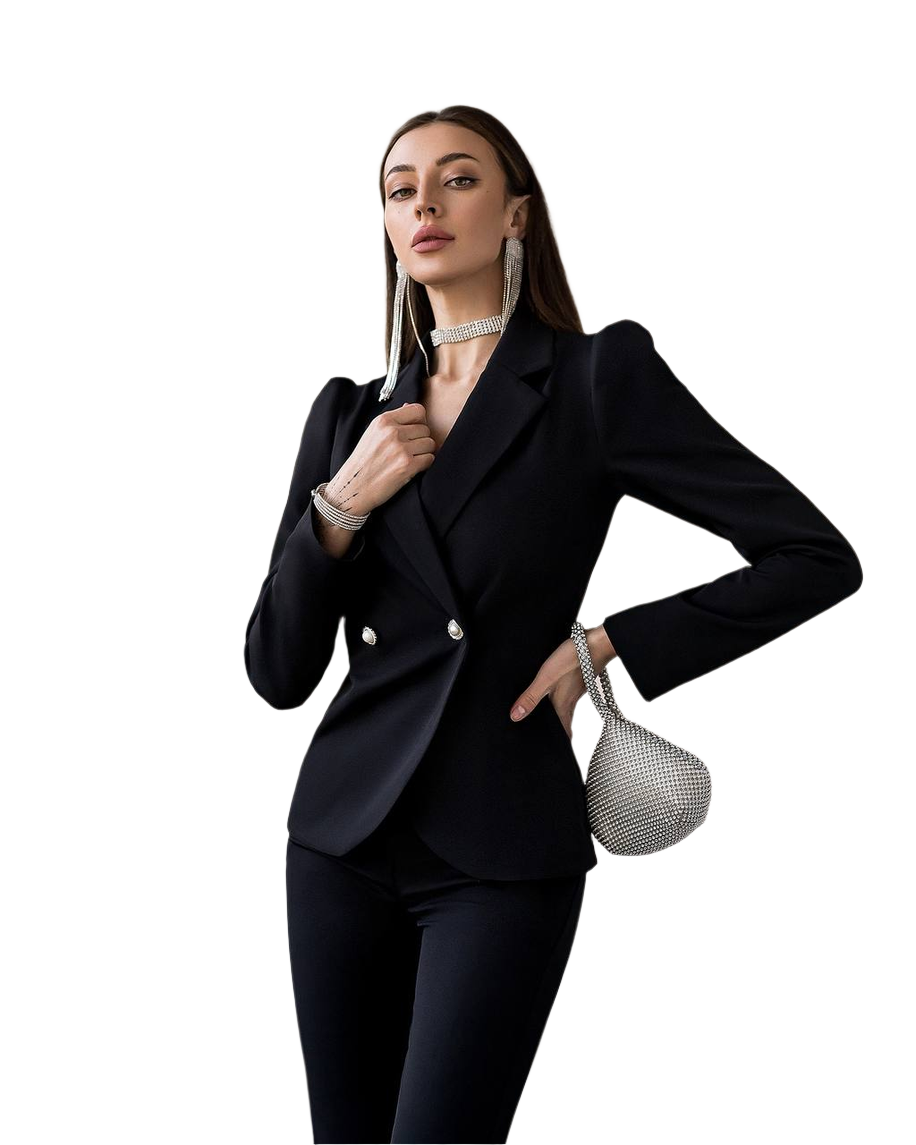Woman in a black suit holding a silver handbag on a white background