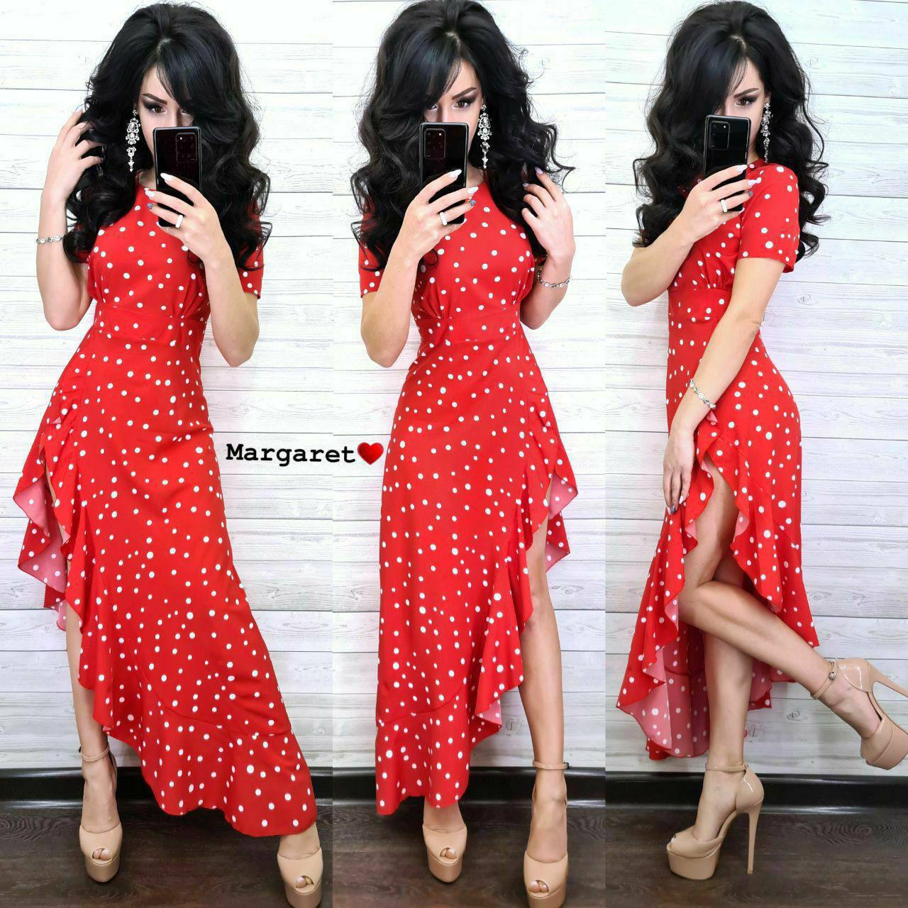 Three images of a woman wearing a red polka dot dress with a slit, posing against a white wall.