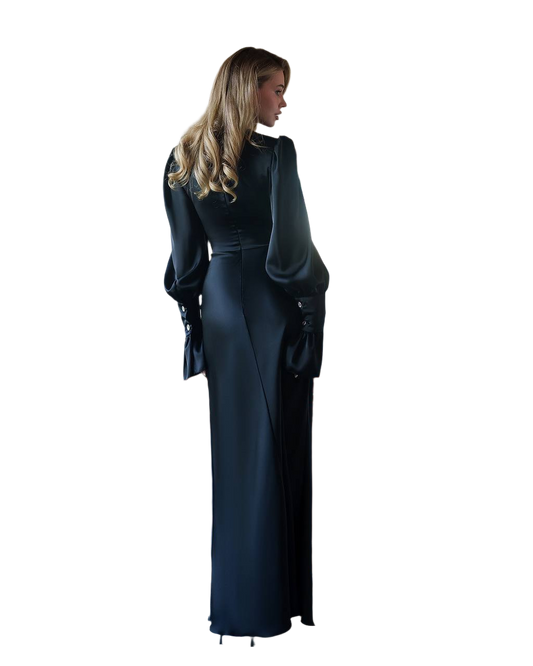 Woman wearing a long black dress with a fitted bodice and flowing skirt on a white background