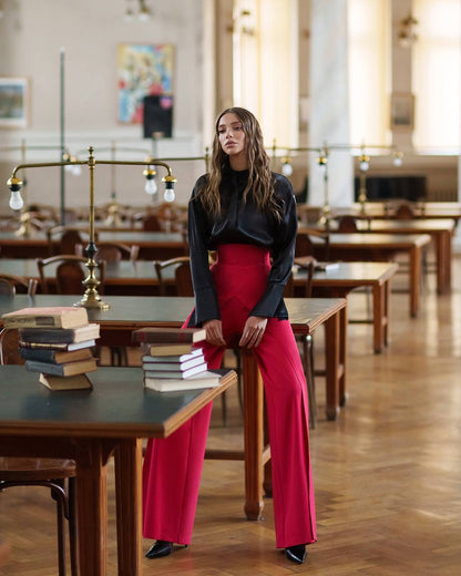 Woman in a library setting with books and tables