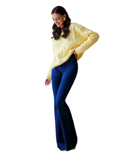 Woman wearing a yellow sweater and blue pants on a white background