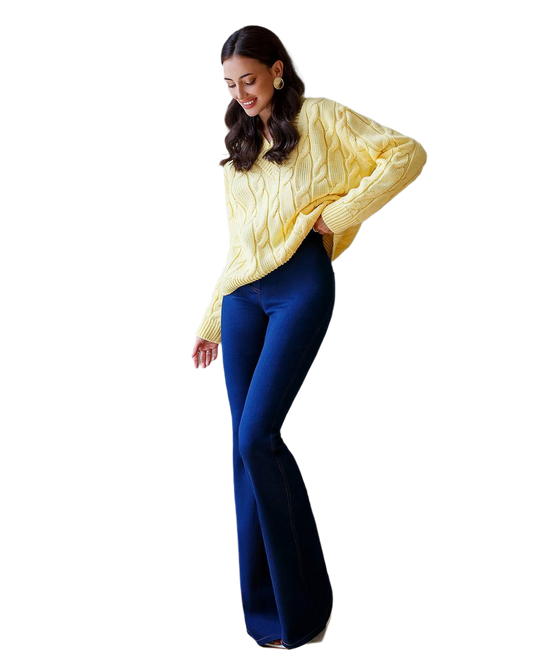 Woman wearing a yellow sweater and blue pants on a white background