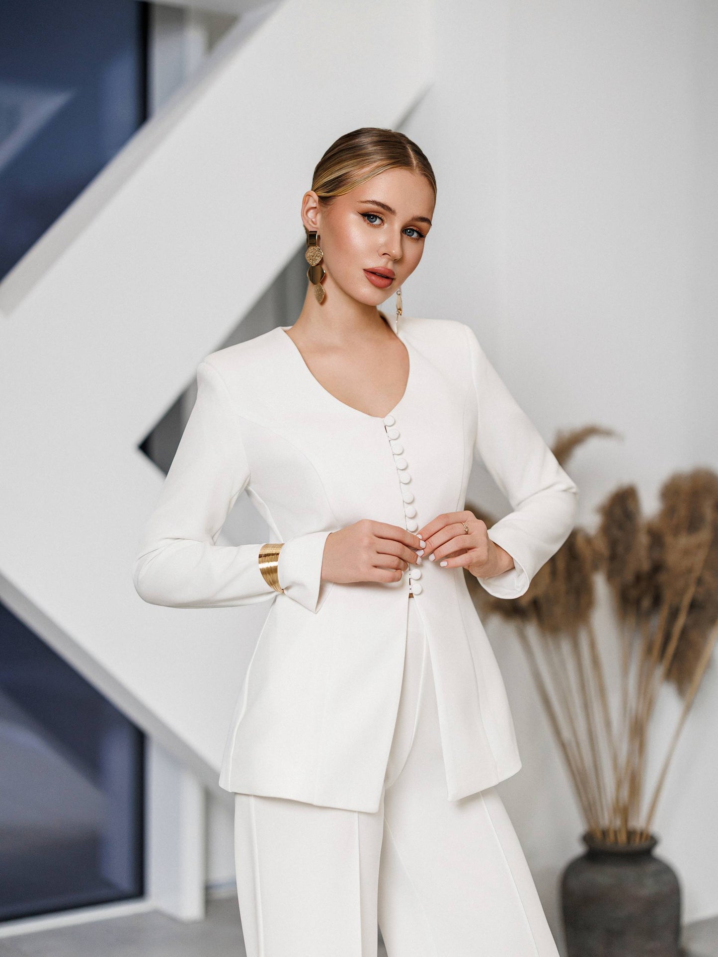 Woman wearing a white outfit with a modern interior background