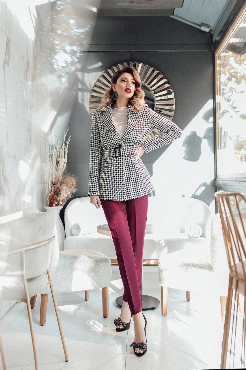 Woman in a stylish outfit standing in a modern interior setting