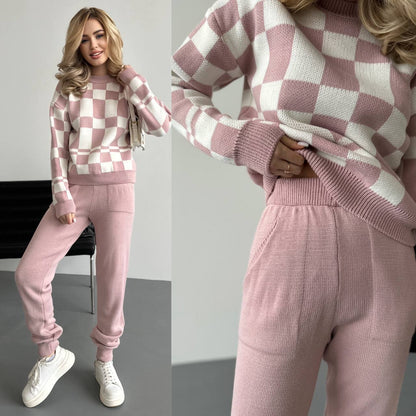 Woman wearing a pink and white checkered sweater and pants set with close-up details.