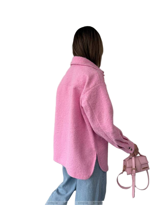 Person wearing a pink coat holding a matching handbag on a white background