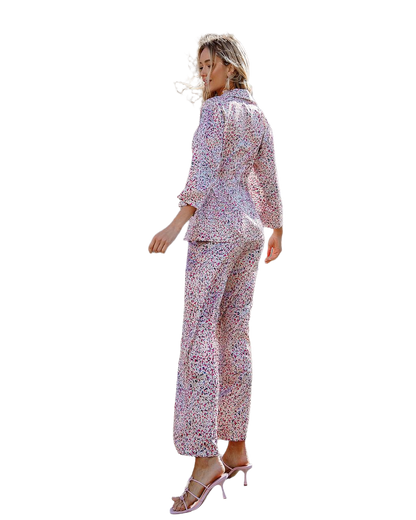 Woman wearing a floral pajama set on a white background