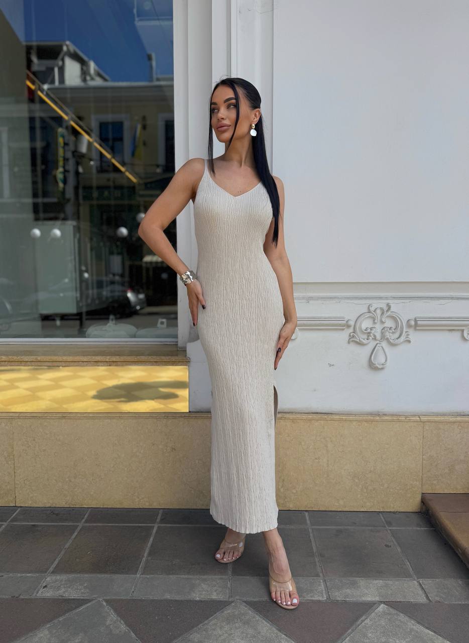Woman in a white dress standing outside a building