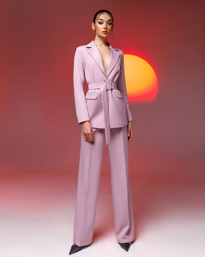 Woman wearing a light purple suit with a sunset in the background