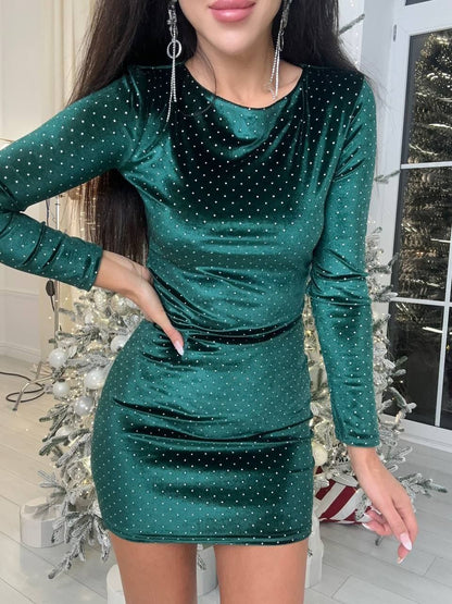 Woman wearing a green sequin dress with Christmas decorations in the background