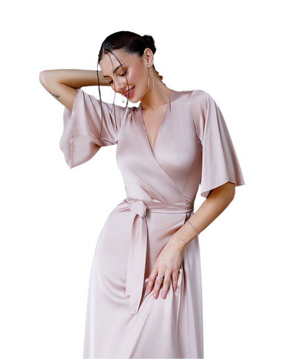 Woman wearing a light pink dress on a white background
