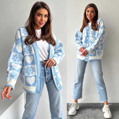 Woman wearing a blue and white patterned cardigan with jeans and white sneakers on a plain background