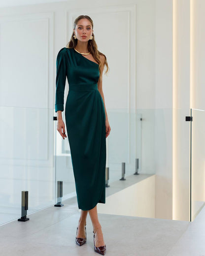 Woman wearing a green dress in a modern interior setting