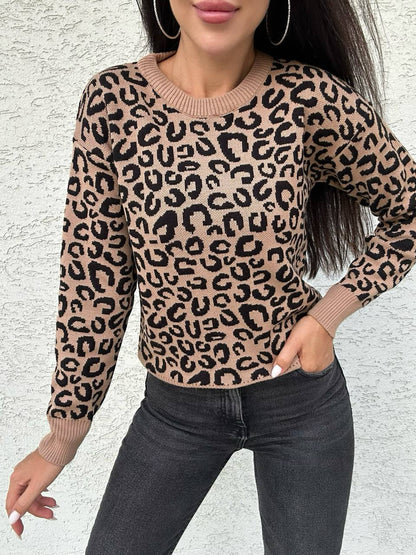 Woman wearing a leopard print sweater against a light gray background