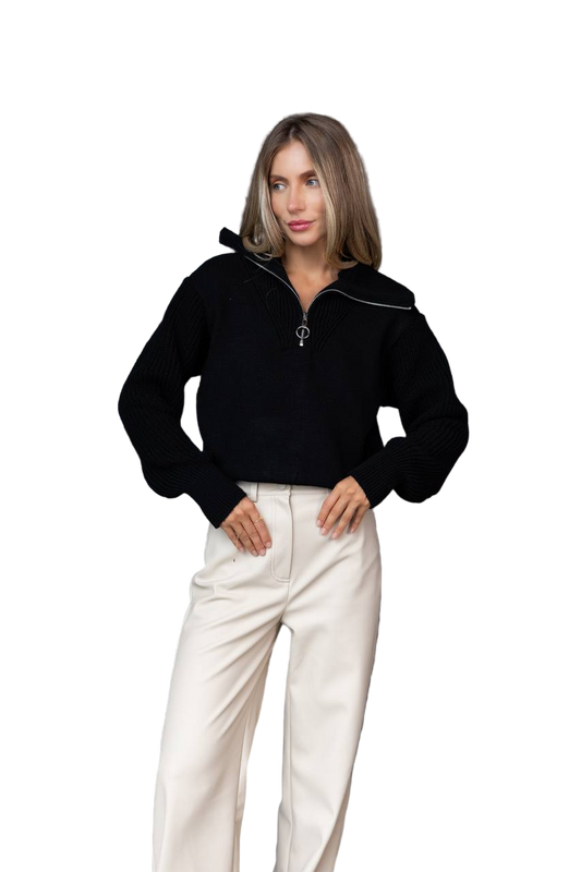 Woman wearing a black sweater and white pants on a white background