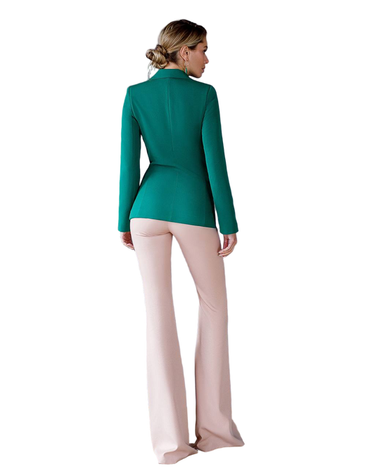 Woman wearing a green blazer and pink pants on a white background
