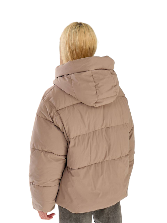 Person wearing a beige puffer jacket on a white background